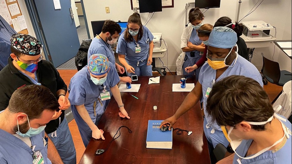 doctors in hospital scrubs working on a task