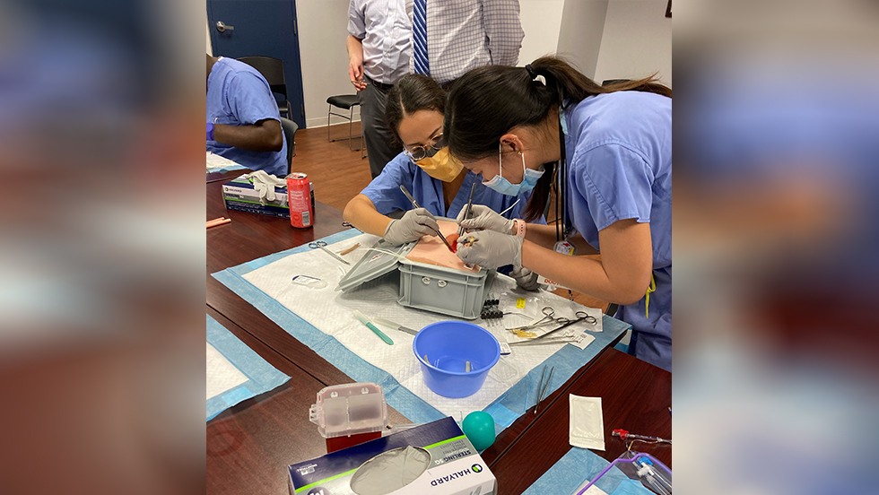 two people working on a surgical dummy