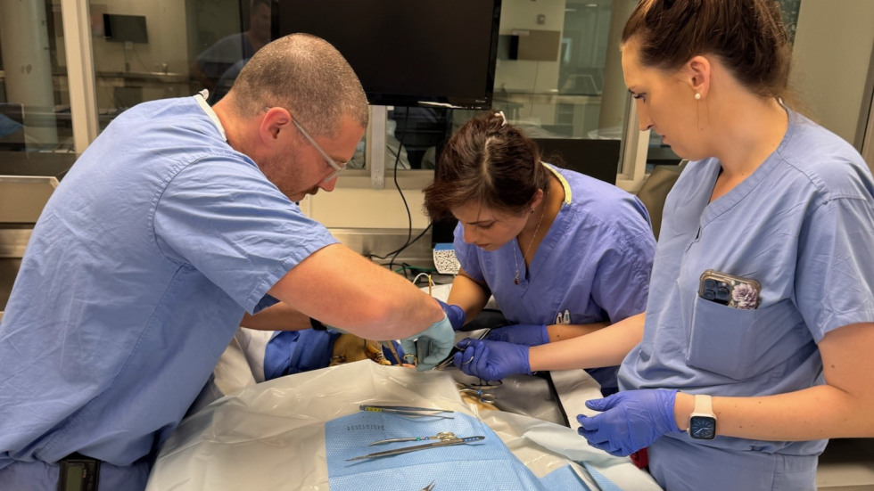 doctors in scrubs practicing surgical skills