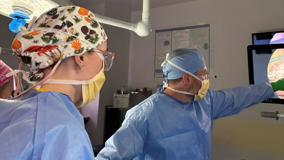 doctors dressed in scrubs looking at screen