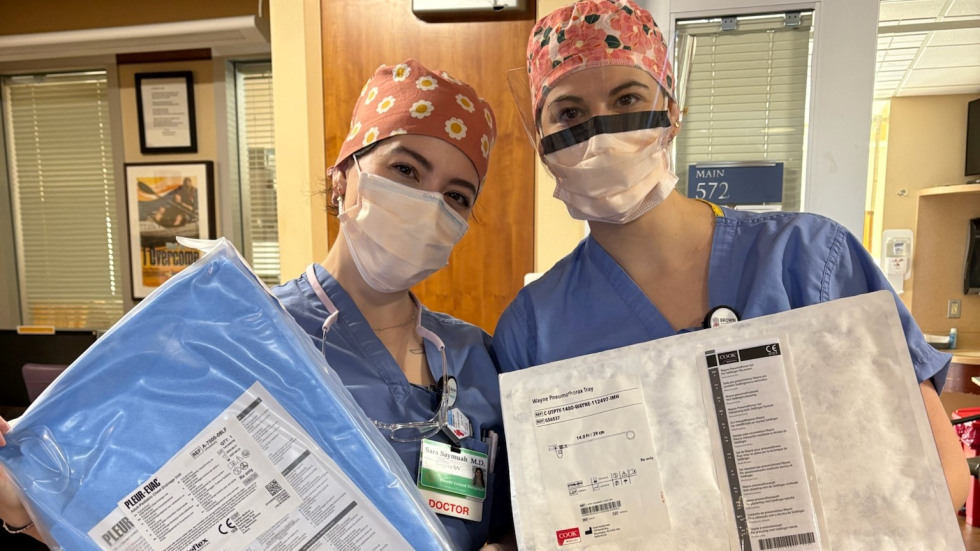 two doctors in scrubs with surgical prep kits