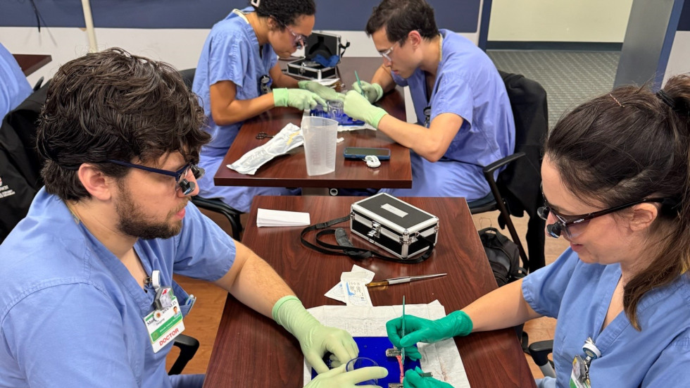 four residents practicing vascular anastomsis